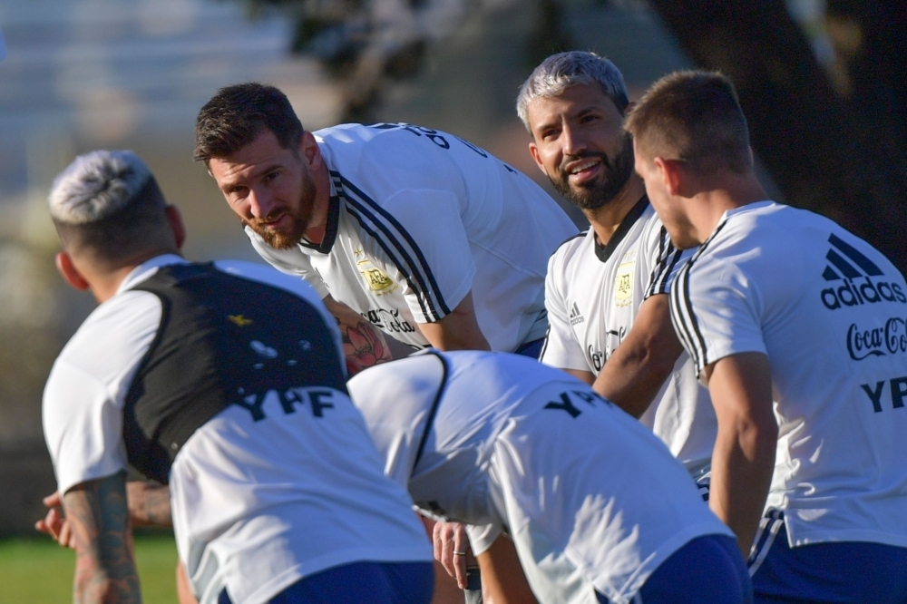 Argentina's Lionel Messi (2-L) and Argentina's Sergio Aguero (2-R) speak to teammates during a practice session in Belo Horizonte, Brazil, on Monday, on the eve of the Copa America tournament semi-final football match between Argentina and Brazil. — AFP