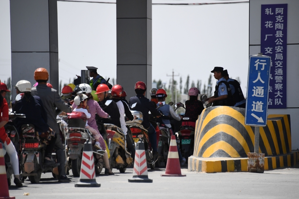 This photo taken on June 4 shows a police checkpoint on a road near a facility believed to be a re-education camp where mostly Muslim ethnic minorities are detained, north of Akto in China's western Xinjiang region. -Courtesy photo
  