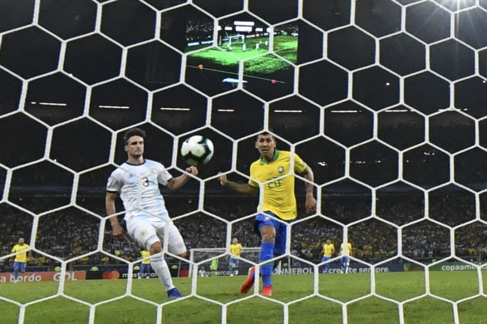 Brazil's Gabriel Jesus (2-L) scores past Argentina's goalkeeper Franco Armani during their Copa America football tournament semifinal match at the Mineirao Stadium in Belo Horizonte, Brazil, on Tuesday. — AFP