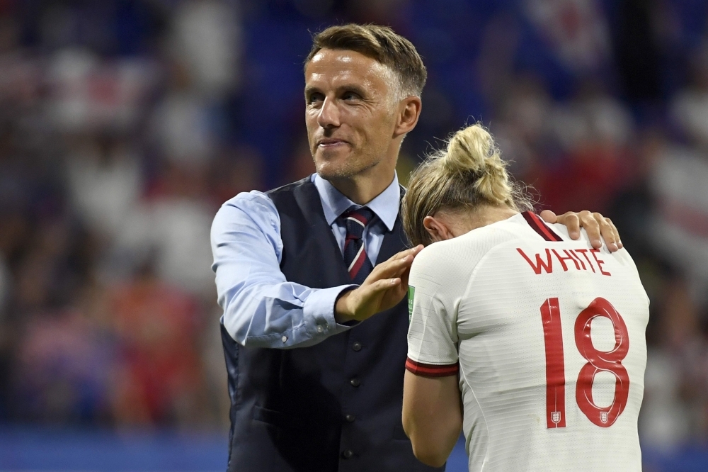 England's coach Phil Neville (C) comforts England's forward Ellen White at the end of the France 2019 Women's World Cup semifinal football match against USA, on Tuesday, at the Lyon Satdium in Decines-Charpieu, central-eastern France. — AFP