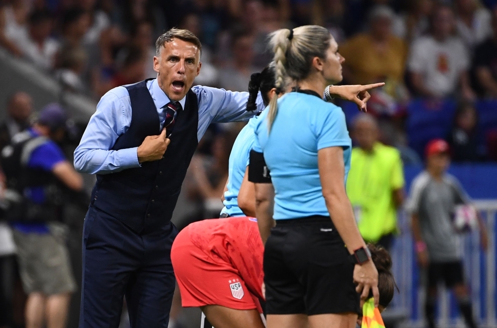 England's coach Phil Neville (C) comforts England's forward Ellen White at the end of the France 2019 Women's World Cup semifinal football match against USA, on Tuesday, at the Lyon Satdium in Decines-Charpieu, central-eastern France. — AFP