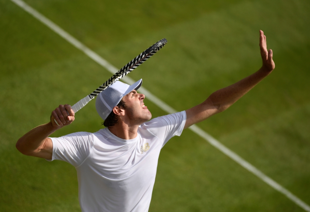 Reilly Opelka of the US in action during his second round Wimbledon match against Switzerland's Stan Wawrinka at the All England Lawn Tennis and Croquet Club, London, Britain on Wednesday. — Reuters