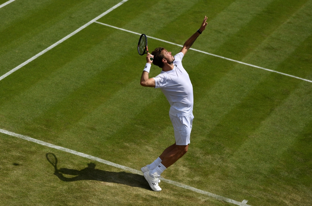 Switzerland's Stan Wawrinka in action during his second round match against Reilly Opelka of the US at the All England Lawn Tennis and Croquet Club, London, Britain on Wednesday. — Reuters