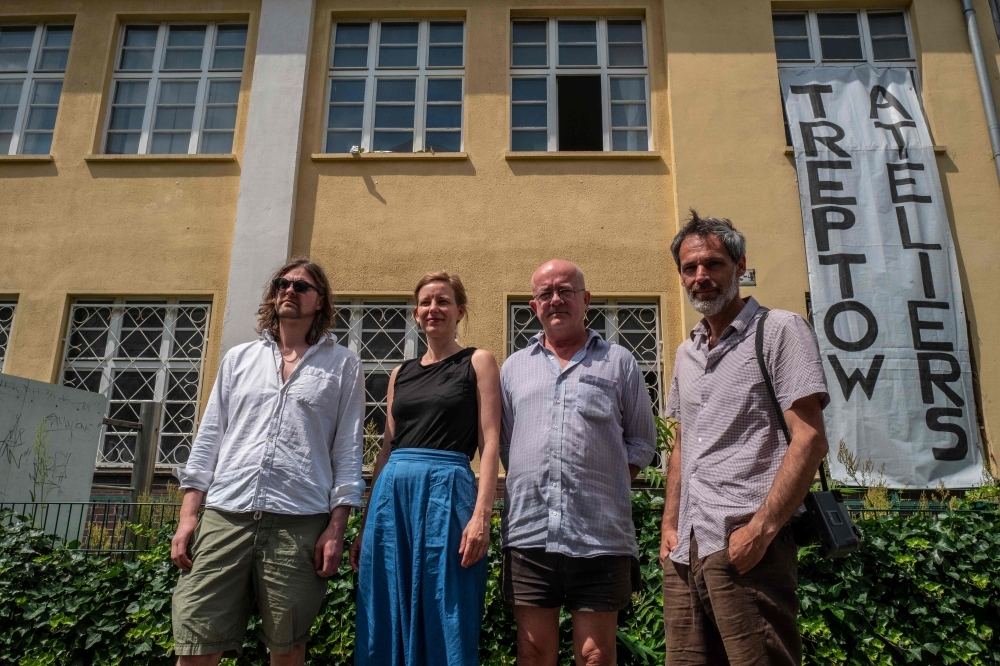 German artist Sebastian Koerbs, left, German artist Lydia Paasche, second left, Irish artist Lorcan O'Byrne, second right, and Italian photographer Michele Caliari, right, pose outside the 