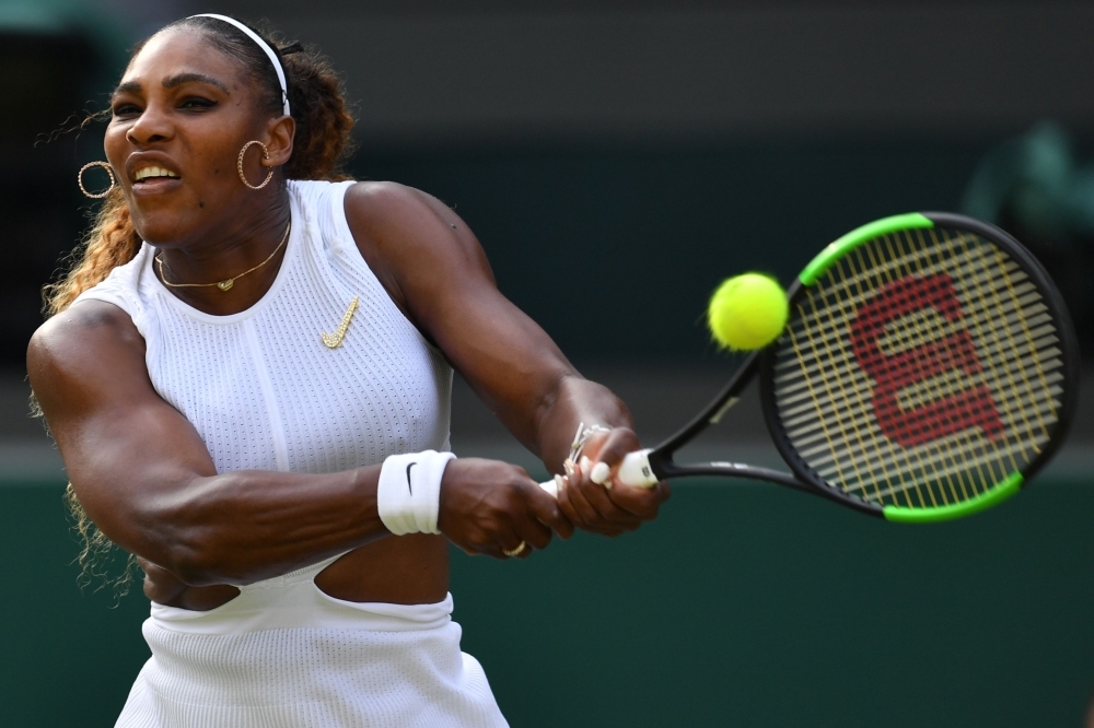 US player Serena Williams returns against Slovakia's Kaja Juvan during their women's singles second round match on the fourth day of the 2019 Wimbledon Championships at The All England Lawn Tennis Club in Wimbledon, southwest London, on Thursday. — AFP