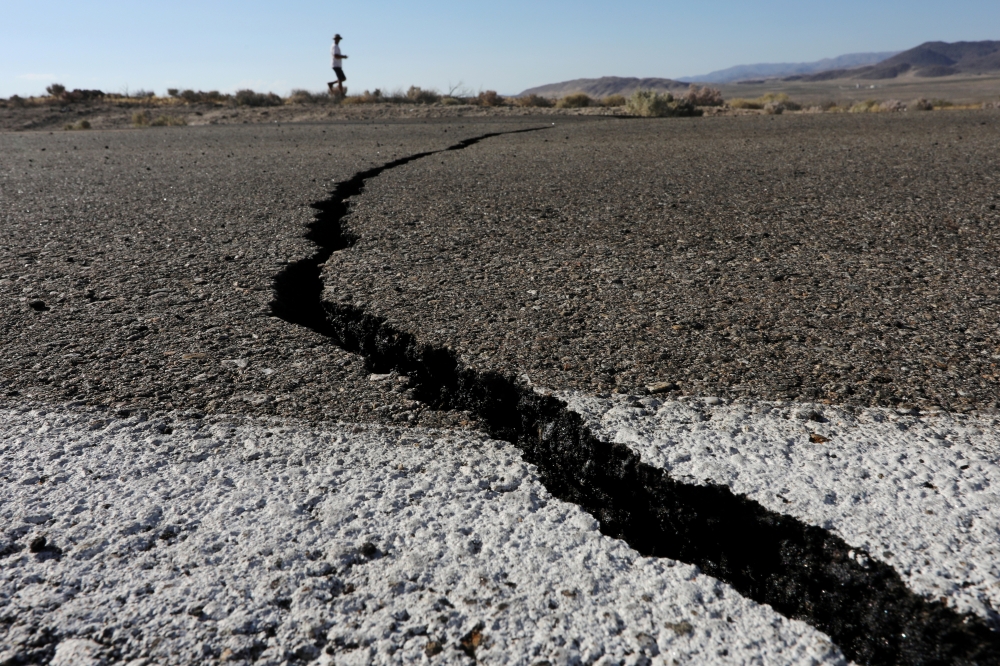 Fissures that opened up under a highway during a powerful earthquake that struck Southern California are seen near the city of Ridgecrest, California, on Thursday. — Reuters