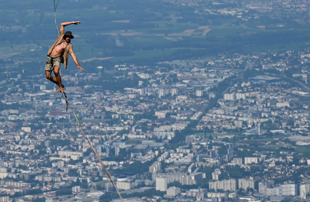 A man walks on a slackline during the 7th edition of the European 'Marmotte Highline Project' (MHP) festival in Lans-en-Vercors, near Grenoble, eastern France, on Thursday. The event, during which the participants will be able to evolve on the various high lines located in the Regional Natural Park of Vercors, takes place until July 7, 2019. — AFP