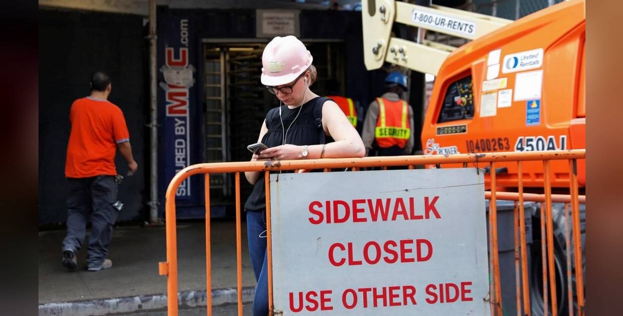 A female construction worker stands outside a construction site in Manhattan, New York, on October 3, 2018. — Reuters