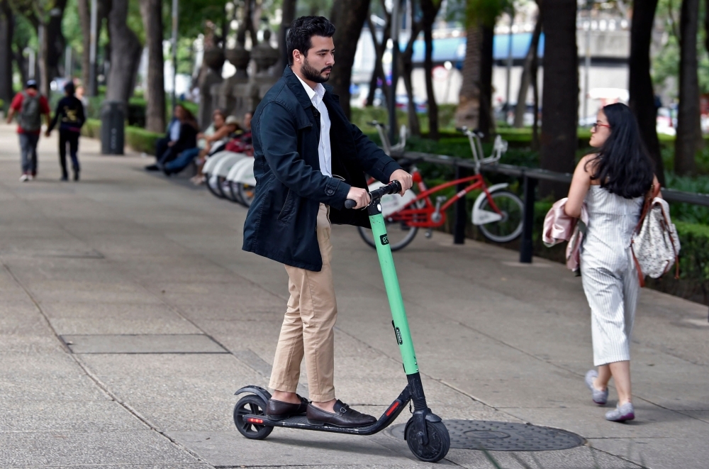 A man rides a rented electric scooter at Juarez neighborhood in Mexico City in this July 2, 2019 file photo. — AFP