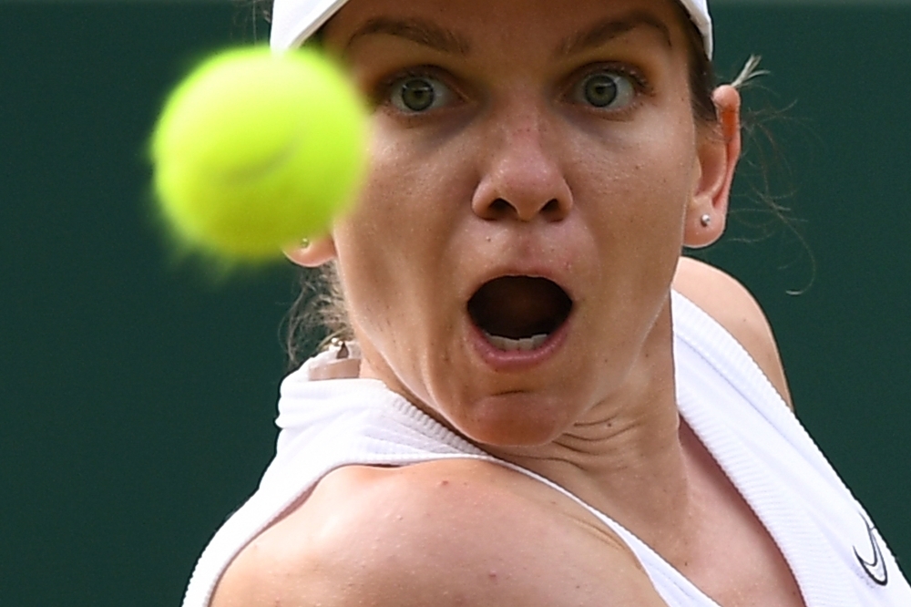 Romania's Simona Halep eyes the ball to return against Belarus's Victoria Azarenka during their women's singles third round match on the fifth day of the 2019 Wimbledon Championships at The All England Lawn Tennis Club in Wimbledon, southwest London, on Friday. — AFP
