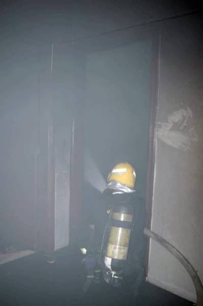 Firefighters enter the burning apartment in Al-Faisaliyyah district of Riyadh.