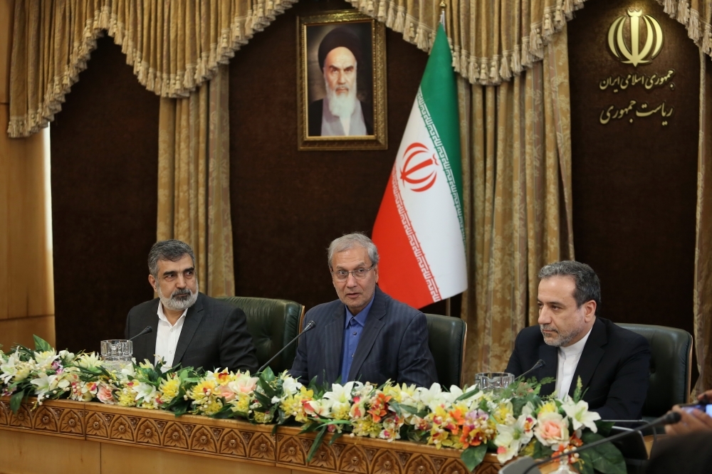 A handout picture provided by the Iranian presidency on Sunday shows (L to R) Iran's Atomic Energy Organization spokesman Behrouz Kamalvandi, government spokesman Ali Rabiei, and Deputy Foreign Minister Abbas Araghchi giving a joint press conference at the presidential headquarters in the capital Tehran. — AFP
