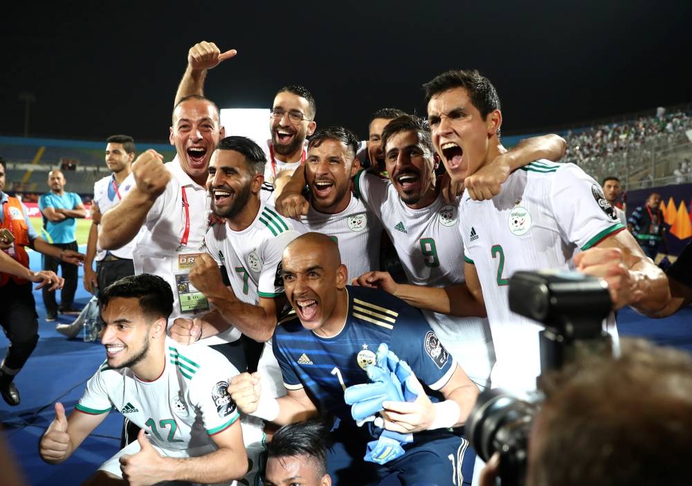 Algerians celebrate winning their match against Guinea in Africa Cup of Nations 2019 in Cairo, Sunday. — Reuters
