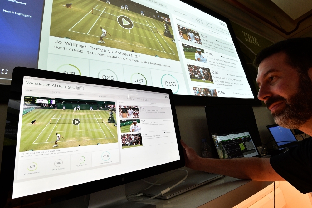 An IBM technician poses with screens showing IBM's AI-generated highlights of play on the sixth day of the 2019 Wimbledon Championships at The All England Lawn Tennis Club in Wimbledon, southwest London, in this July 6, 2019 file photo. — AFP