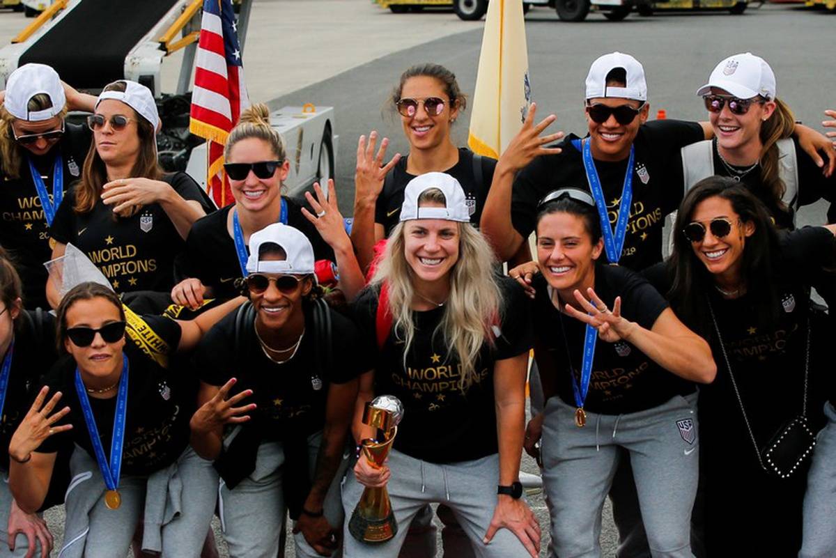 US women soccer players celebrate as they arrive at the Newark International Airport with the trophy for the FIFA Women's World Cup, in Newark. — Courtesy photo