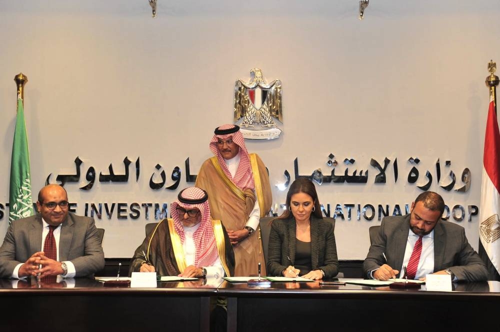 Saudi and Egyptian officials sign the aid agreements in Cairo.
