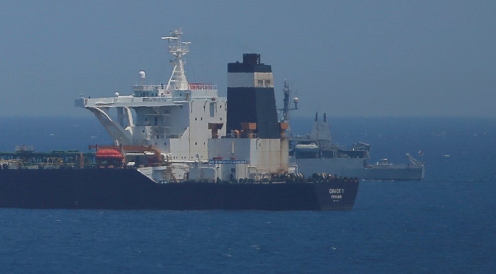 A British Royal Navy patrol vessel guards the oil supertanker Grace 1, suspected of carrying Iranian crude oil to Syria, as it sits anchored in waters of the British overseas territory of Gibraltar, in this July 4, 2019 file photo. — Reuters