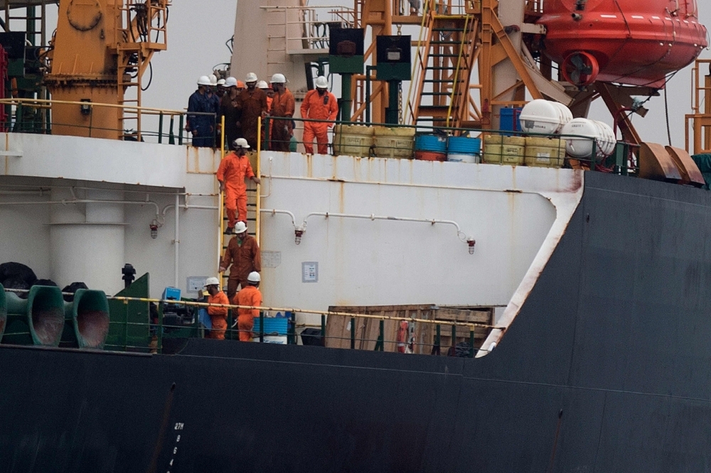 Crew members walk down a ladder on board supertanker Grace 1 off the coast of Gibraltar in this July 6, 2019 file photo. — AFP