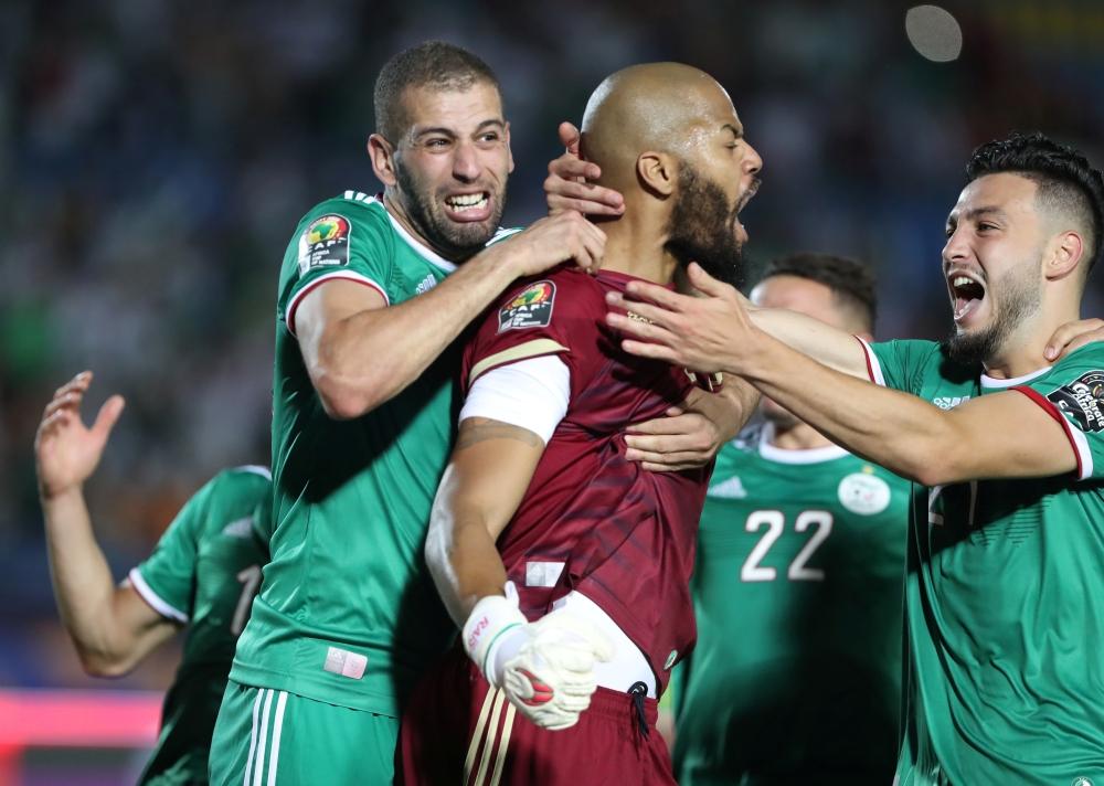 Algeria's Islam Slimani and Rais M'Bolhi celebrate after the Africa Cup of Nations 2019 quarterfinal match against Ivory Coast at the Suez Stadium, Suez, Egypt, on Thursday. — Reuters