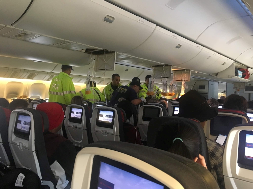 Emergency workers assist passengers of Air Canada AC 33 flight, which diverted to Hawaii after turbulence, at Honolulu airport, Hawaii, US, on Thursday in this image obtained from social media. — Reuters