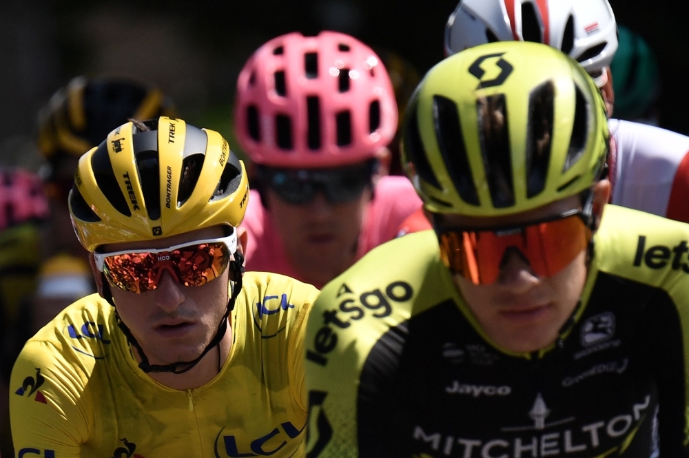 Italy's Giulio Ciccone (L), wearing the overall leader's yellow jersey rides in the pack during the seventh stage of the 106th edition of the Tour de France cycling race between Belfort and Chalon-sur-Saone, on Friday. — AFP 