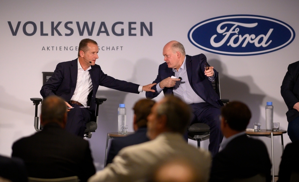 Jim Hackett (R), president and chief executive officer, Ford Motor Company, and Herbert Diess, chief executive officer, Volkswagen Group, attend a press conference Friday in New York City. — AFP