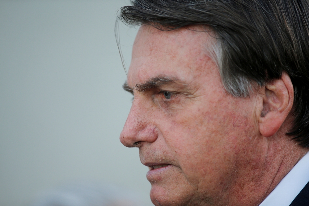 Brazil's President Jair Bolsonaro speaks with journalists after an inauguration ceremony of the new General director of the Brazilian Intelligence Agency (ABIN) in Brasilia, Brazil, on Thursday. — Reuters