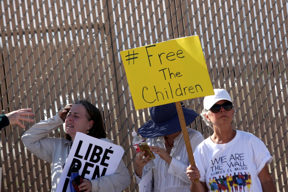 Activists hold placards as they protest against the detention of immigrant children in detention centers, outside a US Customs and Border Protection facilities, during the visit of Secretary of Homeland Security, Kevin McAleenan in Clint, Texas, on Thursday. — Reuters