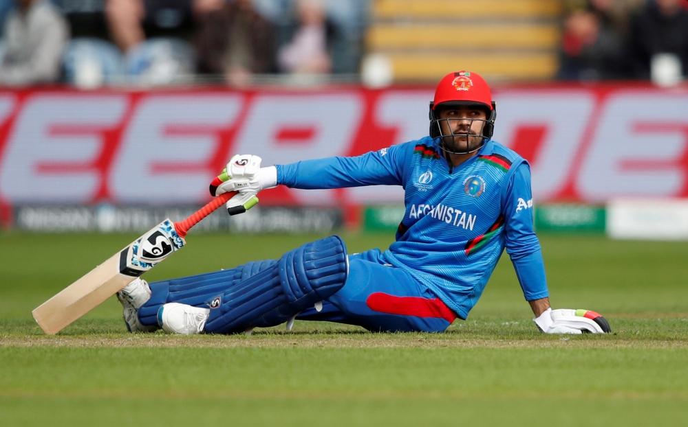 Afghanistan's Rashid Khan looks on after going down during the ICC Cricket World Cup match against South Africa at Cardiff Wales Stadium, Cardiff, Britain. — Reuters