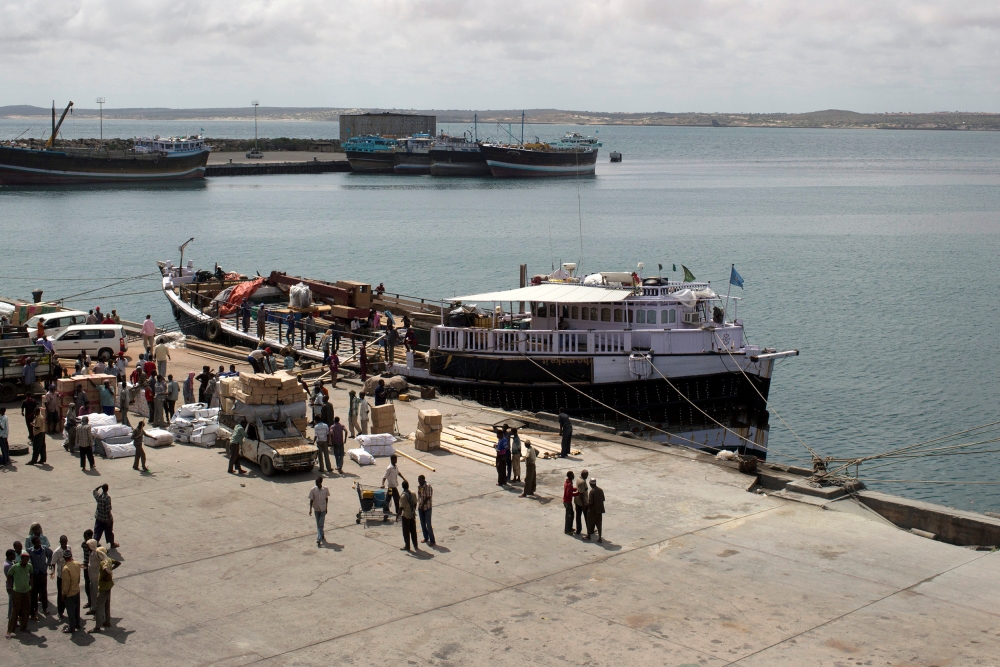 Workers stand at the sea port of the coastal town of Kismayu in southern Somalia in this Nov. 12, 2013. — Reuters