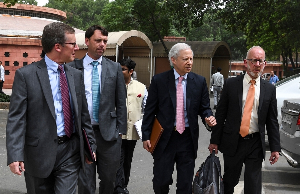 US Ambassador to India Kenneth I. Juster (2R) talks with United States Trade Representative (USTR) Assistant for South and Central Asia Christopher Wilson (R) and Deputy Assistant USTR for South and Central Asia Brendan Lynch (2L) prior to a meeting at the Parliament house in New Delhi on Friday. US and Indian trade teams started negotiations as tensions mount over protectionist measures taken by both sides. — AFP