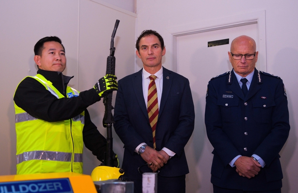 This photo taken on July 4, 2019 shows New Zealand Minister of Police Stuart Nash (C) and deputy police commissioner Mike Clement (R) at a press preview ahead of a gun buyback scheme at the Trentham racecourse in Upper Hutt, near Wellington. Dozens of New Zealanders handed in their firearms on Saturday as a gun buyback scheme went into operation aimed at ridding the country of semi-automatic weapons in the wake of the Christchurch mosque attacks.  —  AFP