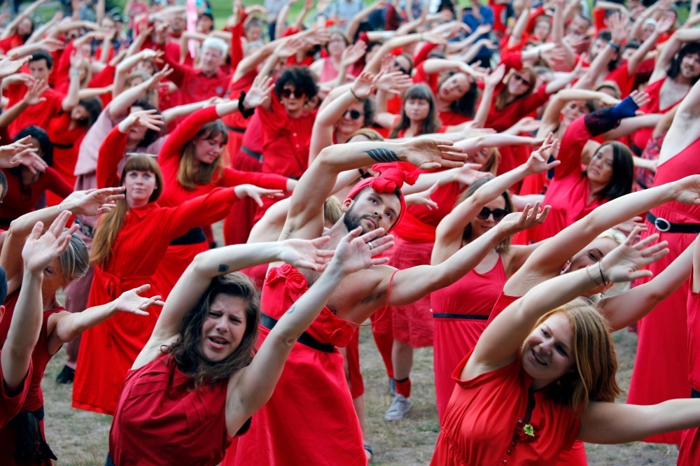 Fans of English singer Kate Bush perform a dance during a flash mob event to mark 