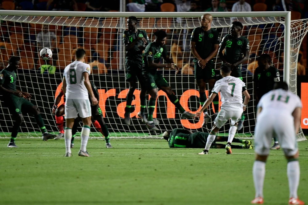 Algeria's forward Riyad Mahrez (R) scores from a free-kick during the 2019 Africa Cup of Nations semifinal football match between Algeria and Nigeria at the Cairo International stadium in Cairo, on Sunday. — AFP