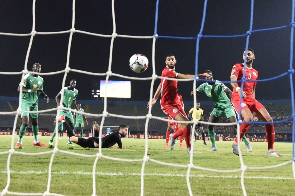 Tunisia's defender Dylan Bronn (R) scores an own goal during the 2019 Africa Cup of Nations semifinal football match between Senegal and Tunisia at the 30 June stadium in Cairo, on Sunday. — AFP