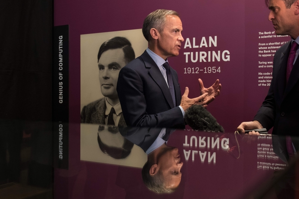 Mark Carney, governor of the Bank of England, is interviewed after attending at a press conference announcing the concept design for the new Bank of England fifty pound banknote, featuring mathematician and scientist Alan Turing, during the presentation at the Science and Industry Museum in Manchester, north-west England on Monday. — AFP