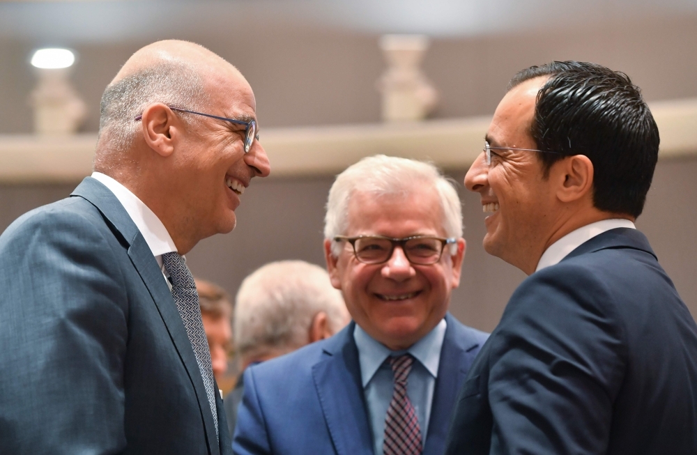 Greek Foreign Minister Nikolaos Georgios Dendias, left, talks with Polish Foreign MinisterJacek Czaputowicz, center and Cyprus Foreign Minister Miro Cerar during a Foreign Affairs meeting at the EU headquarters in Brussels on Monday. — AFP