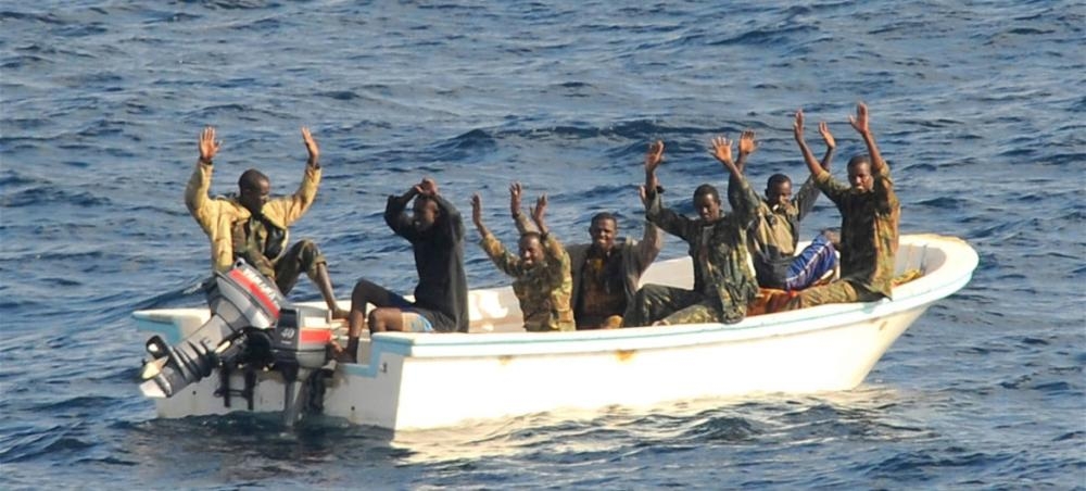 Suspected pirates wait for members of the counter-piracy operation to board their boat in this file picture. — Courtesy photo
