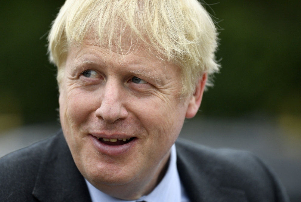 Conservative MP and leadership contender Boris Johnson gestures during a leadership campaign visit to a nursery in Braintree, southeast England, in this July 13, 2019 file photo. — AFP
