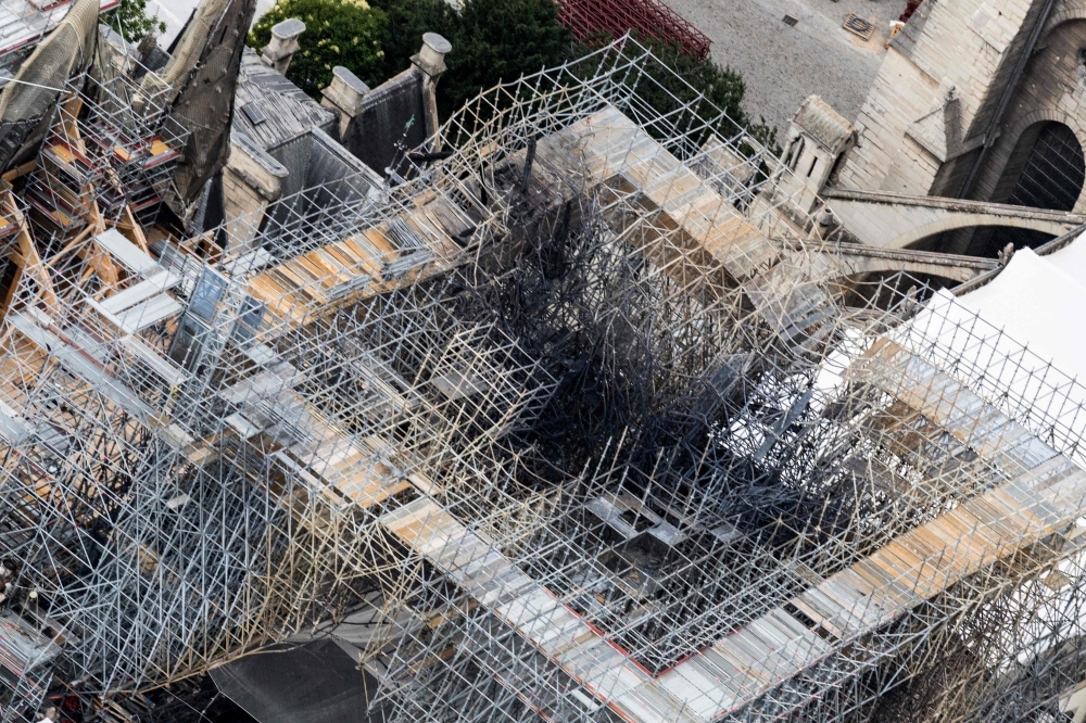 This aerial picture taken on July 14, 2019 in the French capital Paris shows the Notre-Dame de Paris cathedral under construction after it was badly damaged by a huge fire last April 15. — AFP