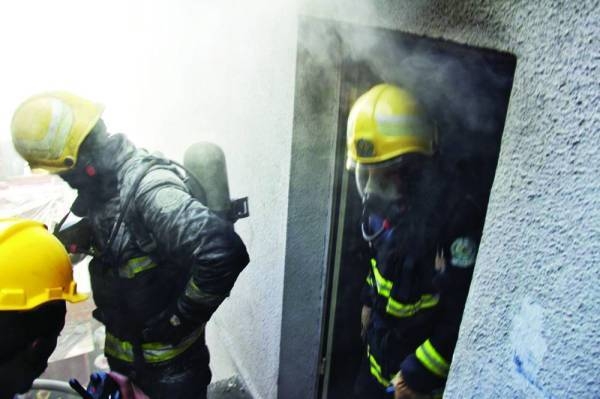 Civil Defense personnel containing the fire.