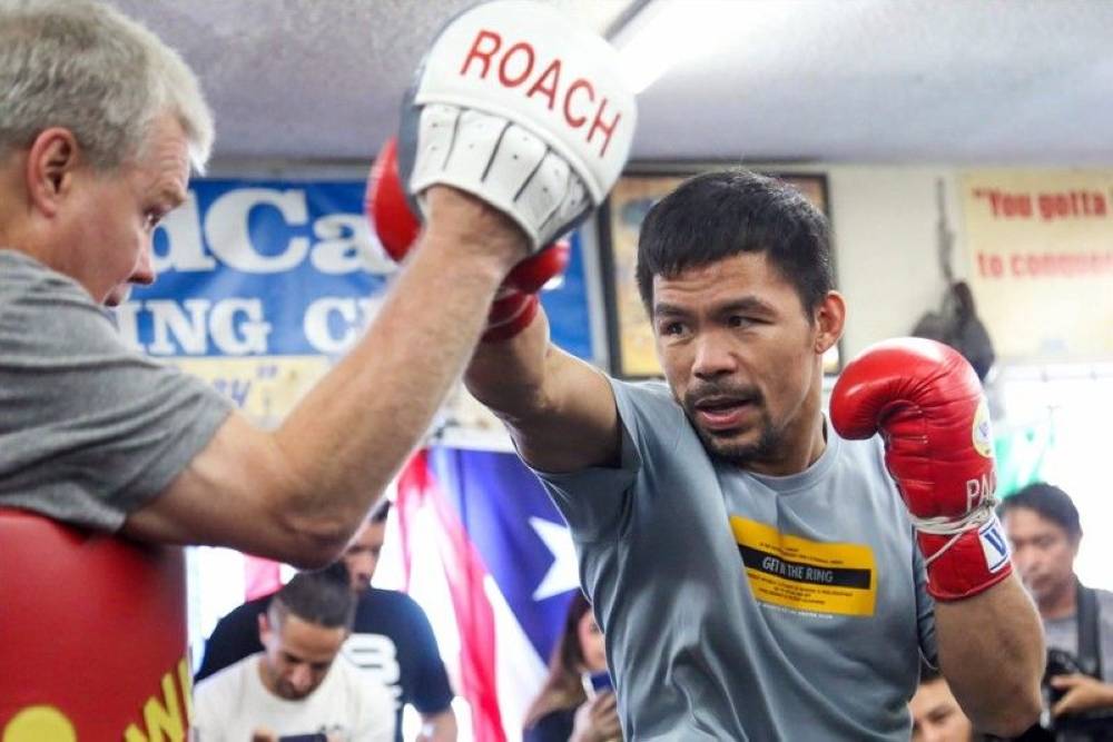 Manny Pacquiao works the pads with Freddie Roach.