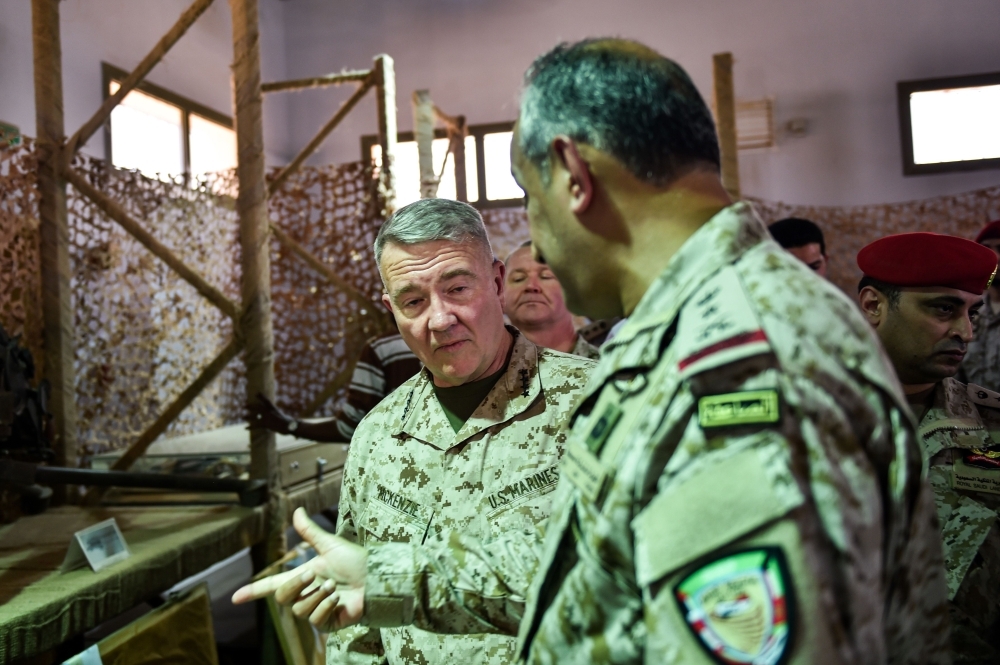 US Marine Corps General Kenneth F. McKenzie Jr. (C, behind), commander of the US Central Command (CENTCOM) and Lieutenant General Fahd bin Turki bin Abdulaziz al-Saud (front), commander of the Saudi-led coalition forces in Yemen, are shown reportedly Iranian weapons seized by Saudi forces from Yemen's Huthi rebels, during his visit to a military base in al-Kharj in central Saudi Arabia on July 18, 2019.  / AFP / Fayez Nureldine
