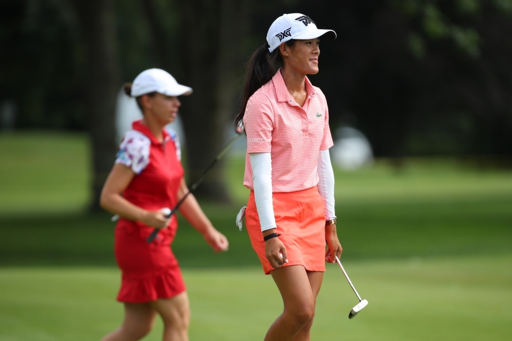 Teammates Karine Icher (L) and Celine Boutier of France walk off the 17th green during round two of the Dow Great Lakes Bay Invitational at Midland Country Club on Thursday in Midland, Michigan.   — AFP