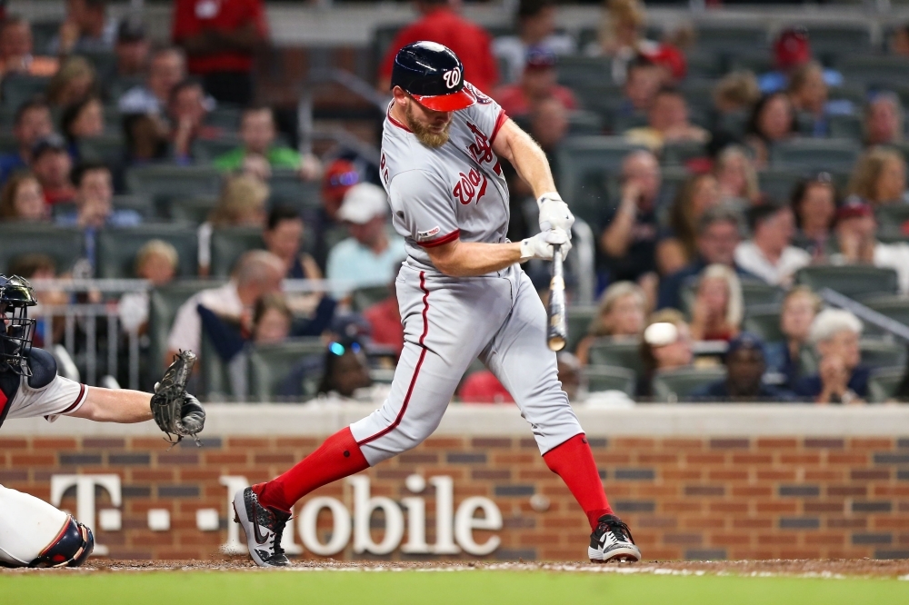 Stephen Strasburg No. 37 of the Washington Nationals singles to left field scoring Brian Dozier No. 9 and Victor Robles No. 16 in the fifth inning during the game against the Atlanta Braves at SunTrust Park on Thursday in Atlanta, Georgia. — AFP