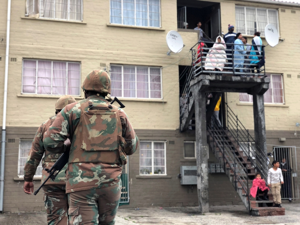 Soldiers patrol as they are deployed to quell gang violence in Manenberg township, Cape Town, South Africa, on Thursday. — Reuters