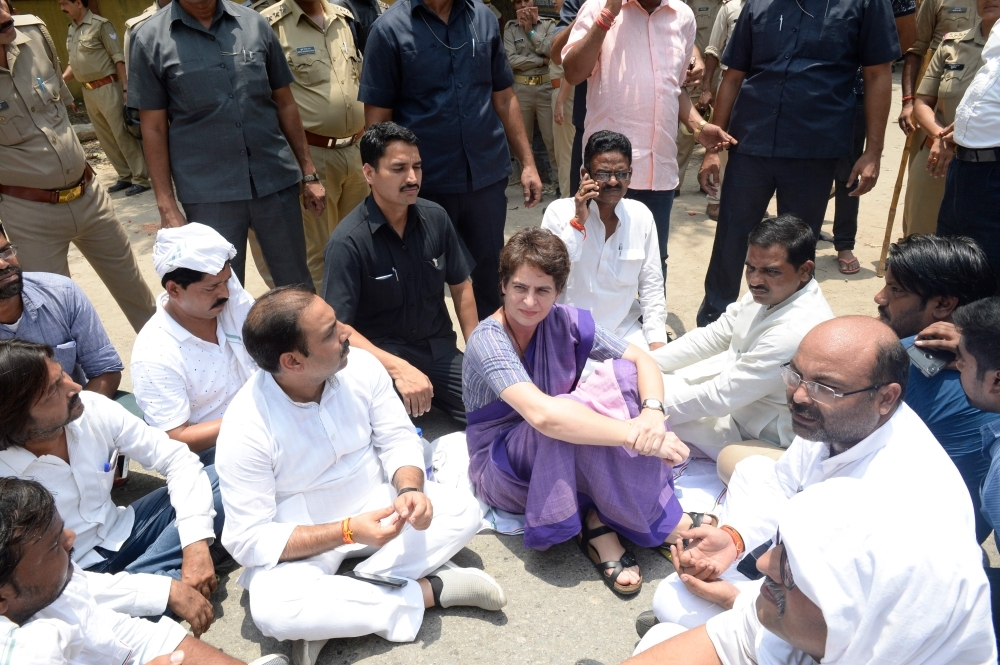 Indian politician Priyanka Gandhi Vadra, center, sits during a protest at Narayanpur District, Mirzapur, after being stopped to meet the victims of a shooting which took place over disputed patch of farmland in the northern Indian state of Uttar Pradesh. — AFP