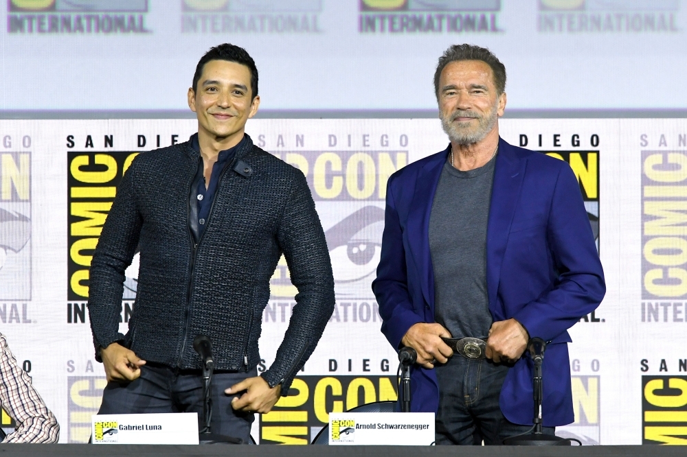 Gabriel Luna and Arnold Schwarzenegger speak at the 