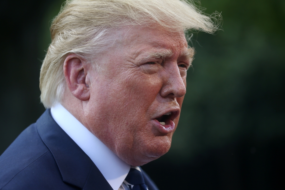 US President Donald Trump talks to reporters as he departs for travel to Bedminster, New Jersey from the South Lawn of the White House in Washington on Friday. -Reuters photo