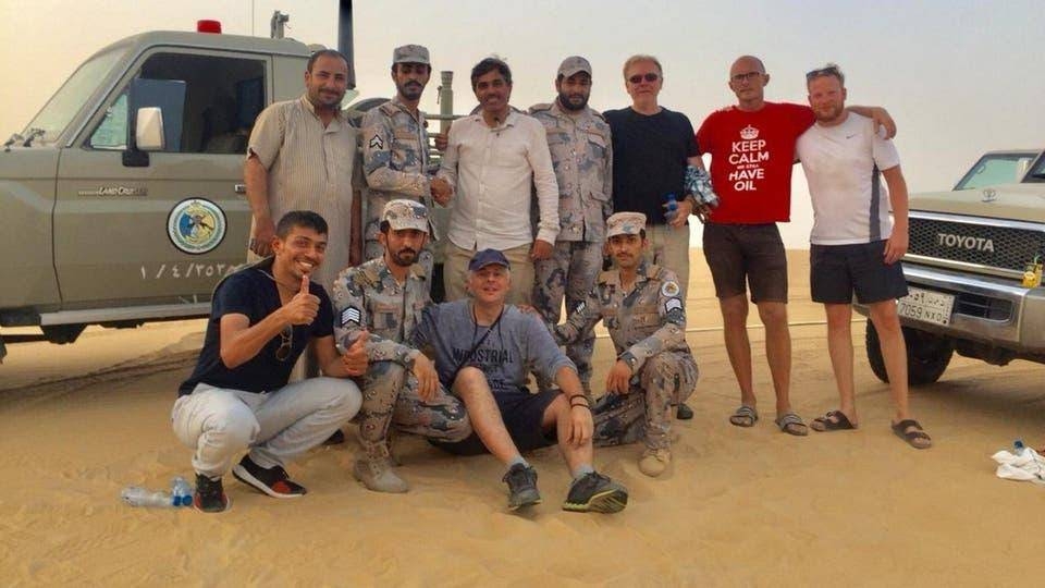 Border Guards personnel pose with the six persons rescued from the Empty Quarter. — SPA
